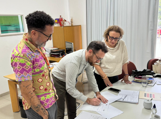 Foto em que representantes das instituições citadas assinam termo de cooperação.